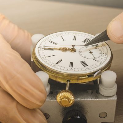 Close up cropped shot of a professional watch craftsman restoring old fashioned mechanical pocket watch at his workshop fix fixing restore repair repairman professionalism accuracy antique hobby