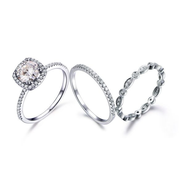Three platinum wedding stack rings: Featuring a classic round halo brilliant cut diamond engagement ring, a three-quarter eternity band pave set with round diamonds, and a full vintage eternity band styled with milgraine details. Jose Jewellers, Benoni.