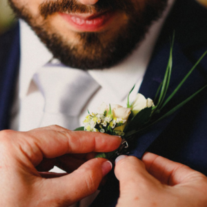 A South African groom getting ready for a wedding, packing a unique mens wedding band safely into his suit jacket pocket.