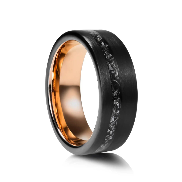 A black men’s wedding ring featuring a textured raw meteorite inlay and a polished rose gold interior.