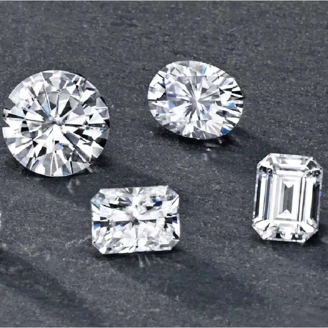 Assorted lab grown diamonds in four distinct cuts: emerald, oval, round, and radiant.