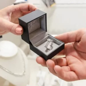 An open jewellery box showcasing expert engagement ring remodelling in South Africa shown by Jose Jewellers.